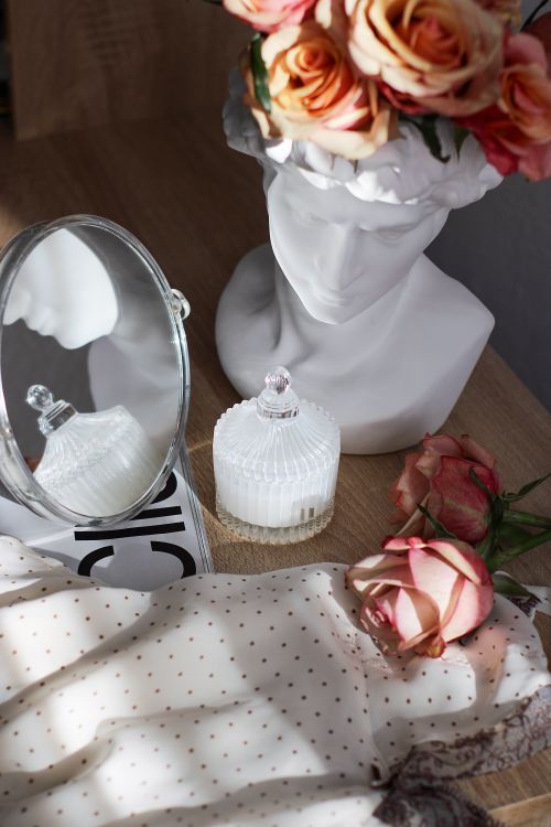 Free Elegant still life featuring a mirror, sculpture, and roses, bathed in soft natural light. Stock Photo