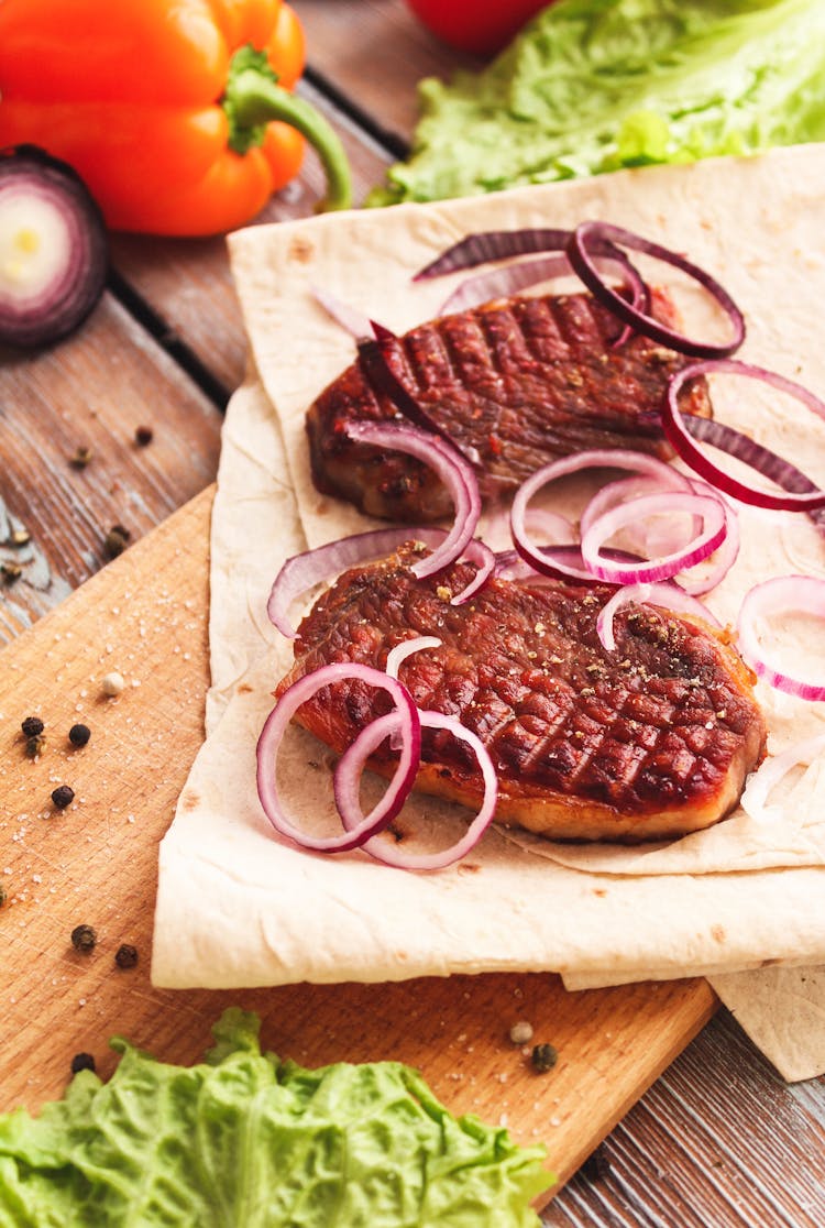 A Tasty Grilled Meat With Slices Of Onions