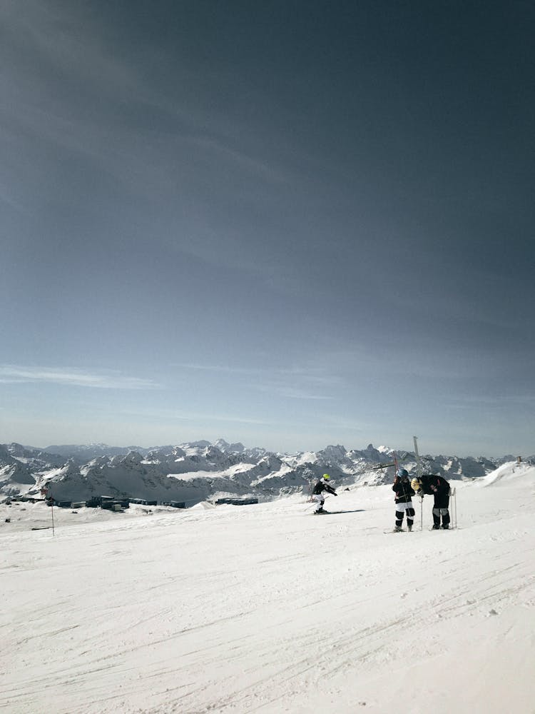 People Skiing In Mountains