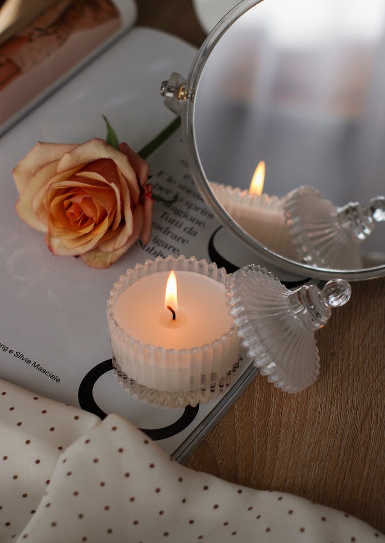 Close-up Of A Candle Near A Rose