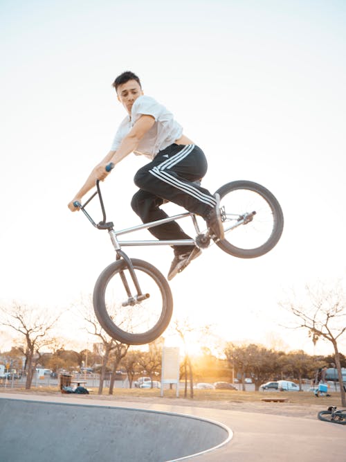 Free Man in White T-shirt Riding on Bicycle Stock Photo