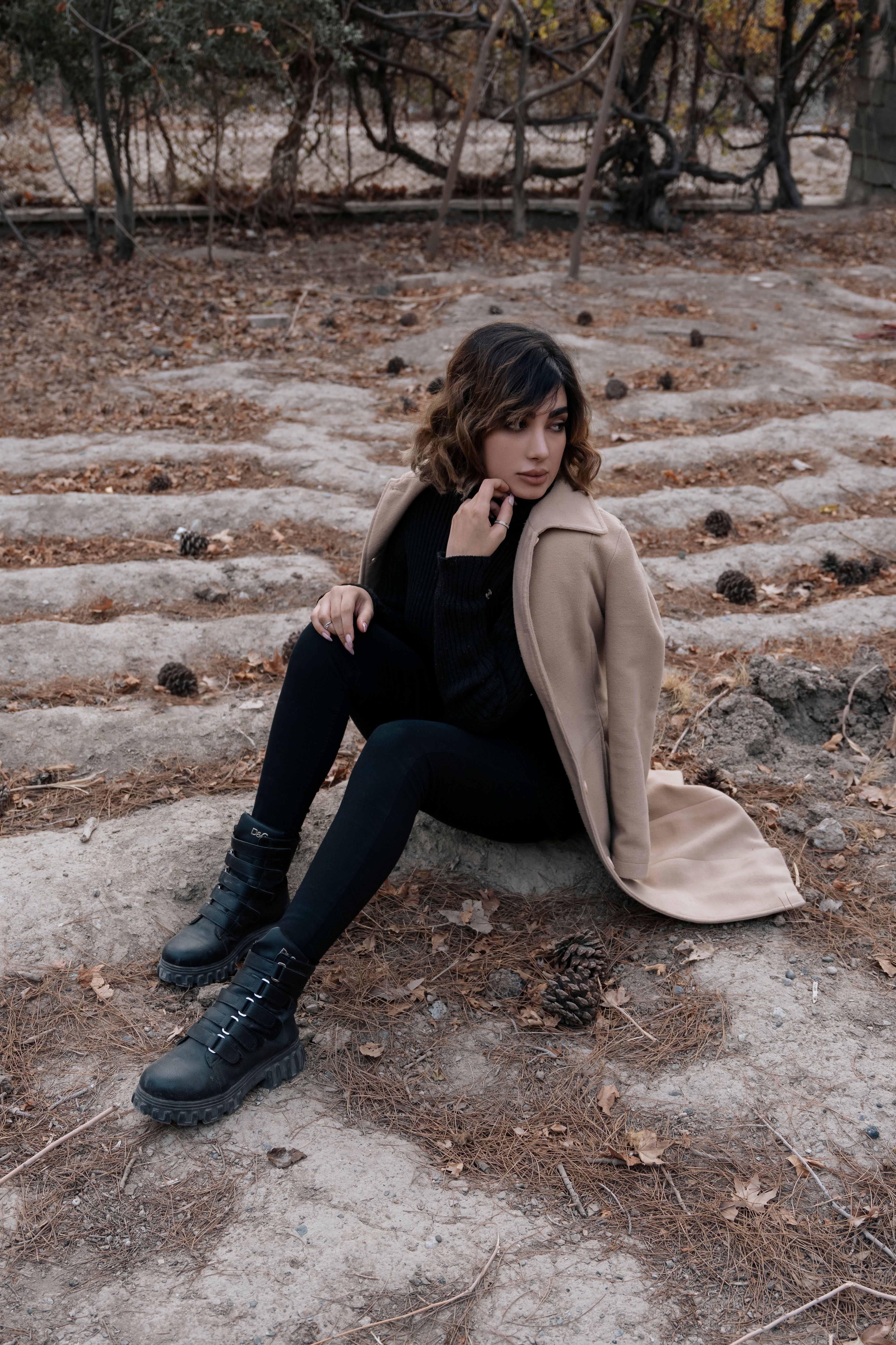 Woman Wearing Brown Coat Sitting on the Ground · Free Stock Photo