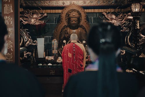 A Monk Praying in front of an Altar