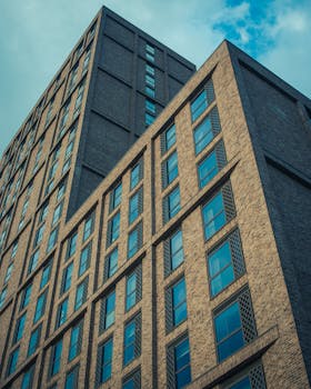 A striking low angle shot of a modern high-rise building in Leeds, featuring geometric design.