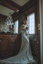 Pregnant Woman Wrapped in Sheet Holding Flowers