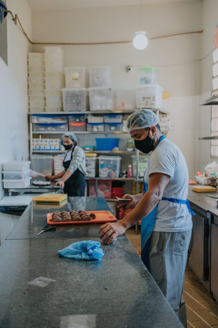 Woman And Man Baking Cookies