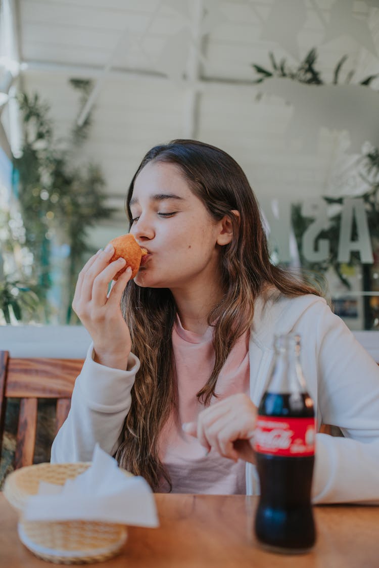 A Woman Eating At A Restaurant