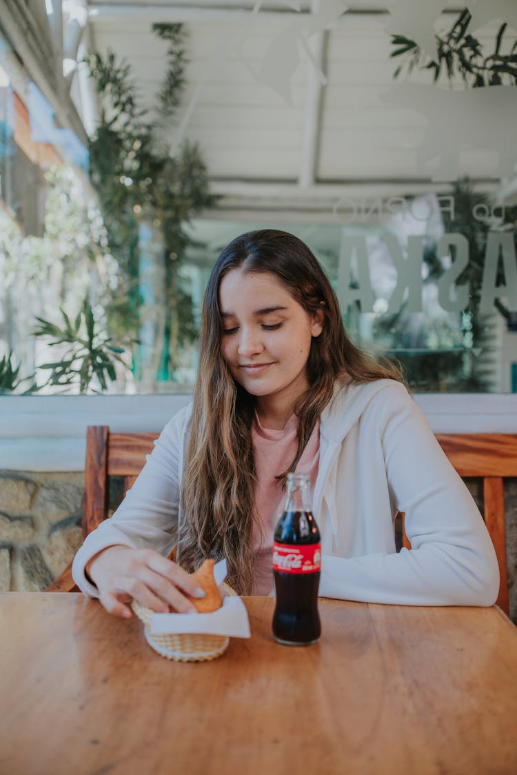 A Woman Sitting In A Restaurant