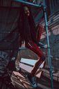 Person in Red Costume Sitting on Scaffolding
