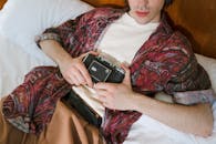 A Selective Focus of a Male Holding an Analog Camera