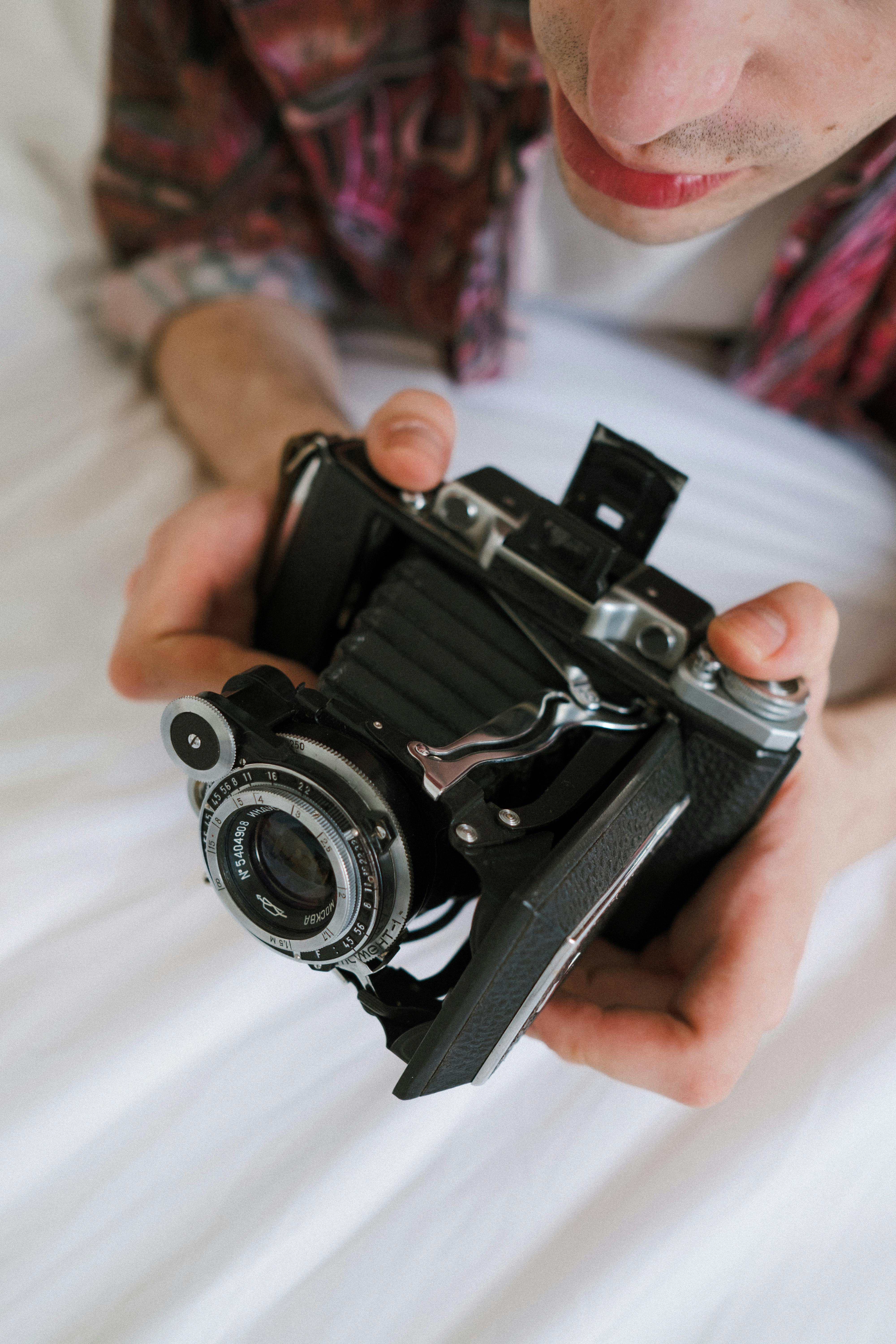 a high angle shot of a male holding an analog camera