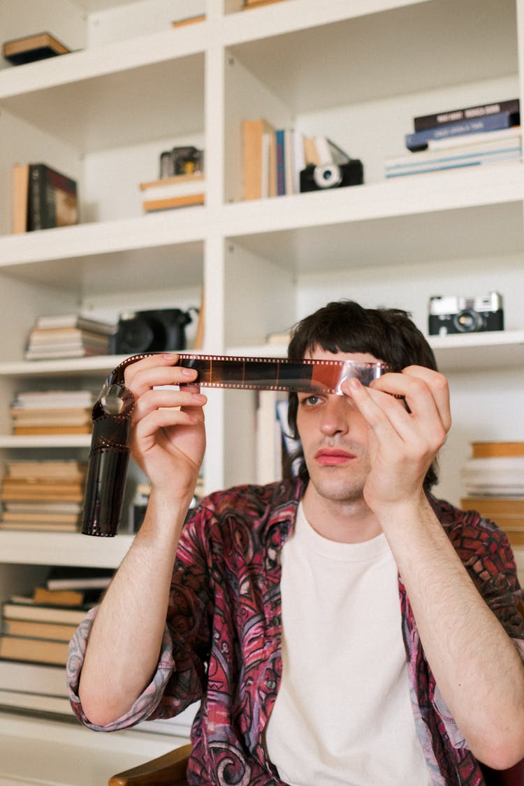 Man Looking At Photographic Film