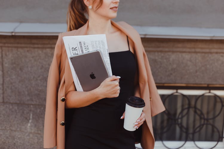 Business Woman Standing Before Building And Holding Tablet And Coffee Cup