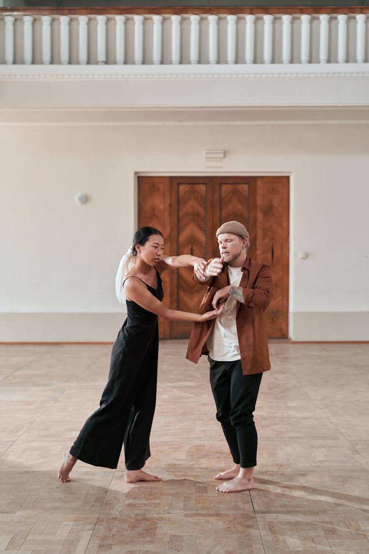 Man And Woman Practicing Hand Movements 