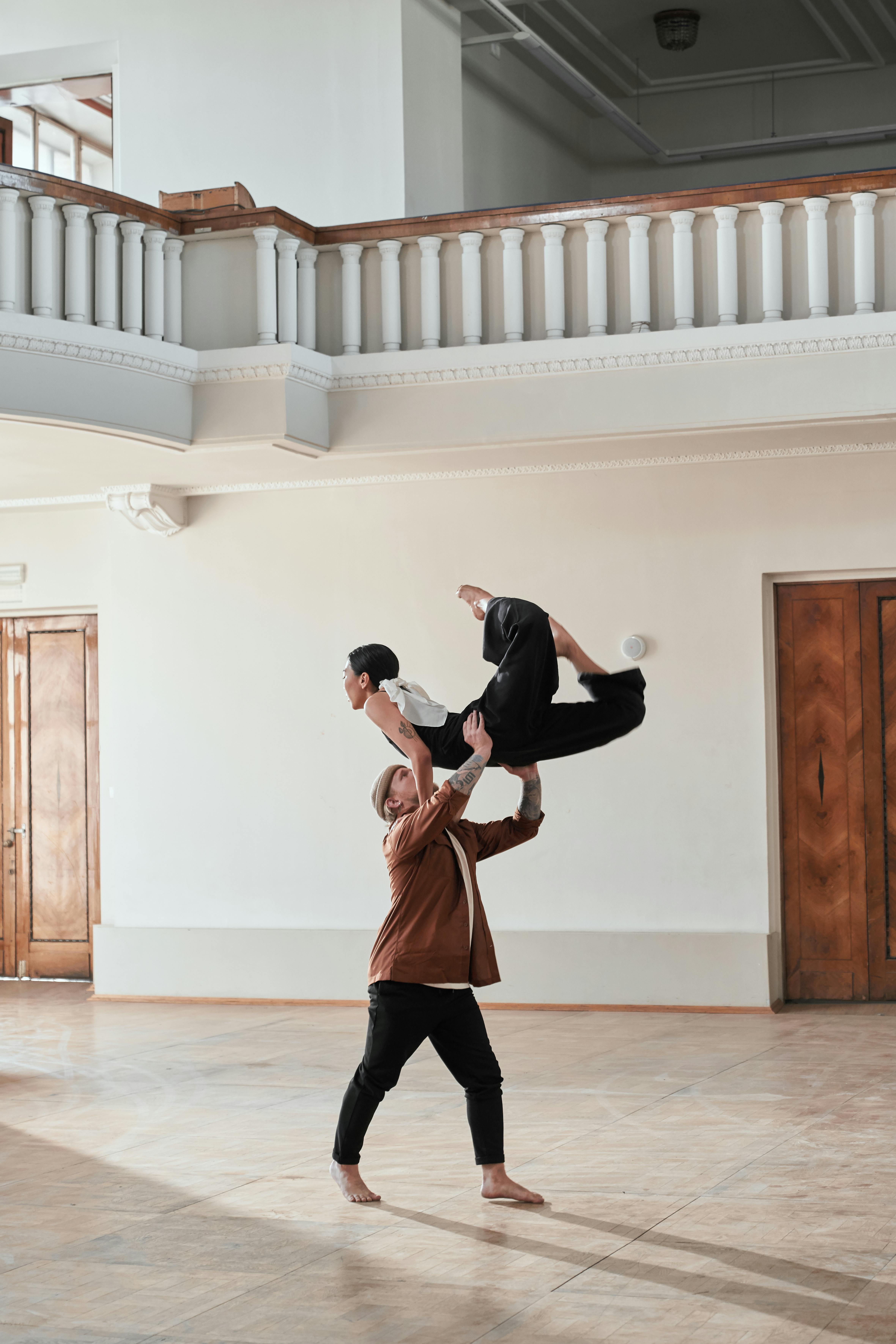 Two Person, Dancers, Woman And Man In Dynamic Action Figure Pose Under  Light On The Grunge Background. Stock Photo, Picture and Royalty Free  Image. Image 95285368.