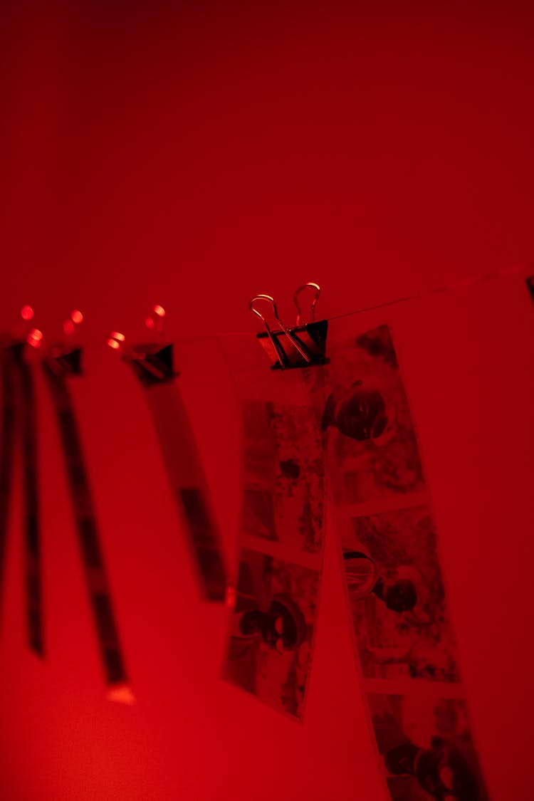 Sections Of Camera Films Hanging In Red Room
