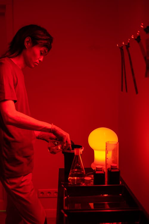 A Man Pouring Liquid on a Canister