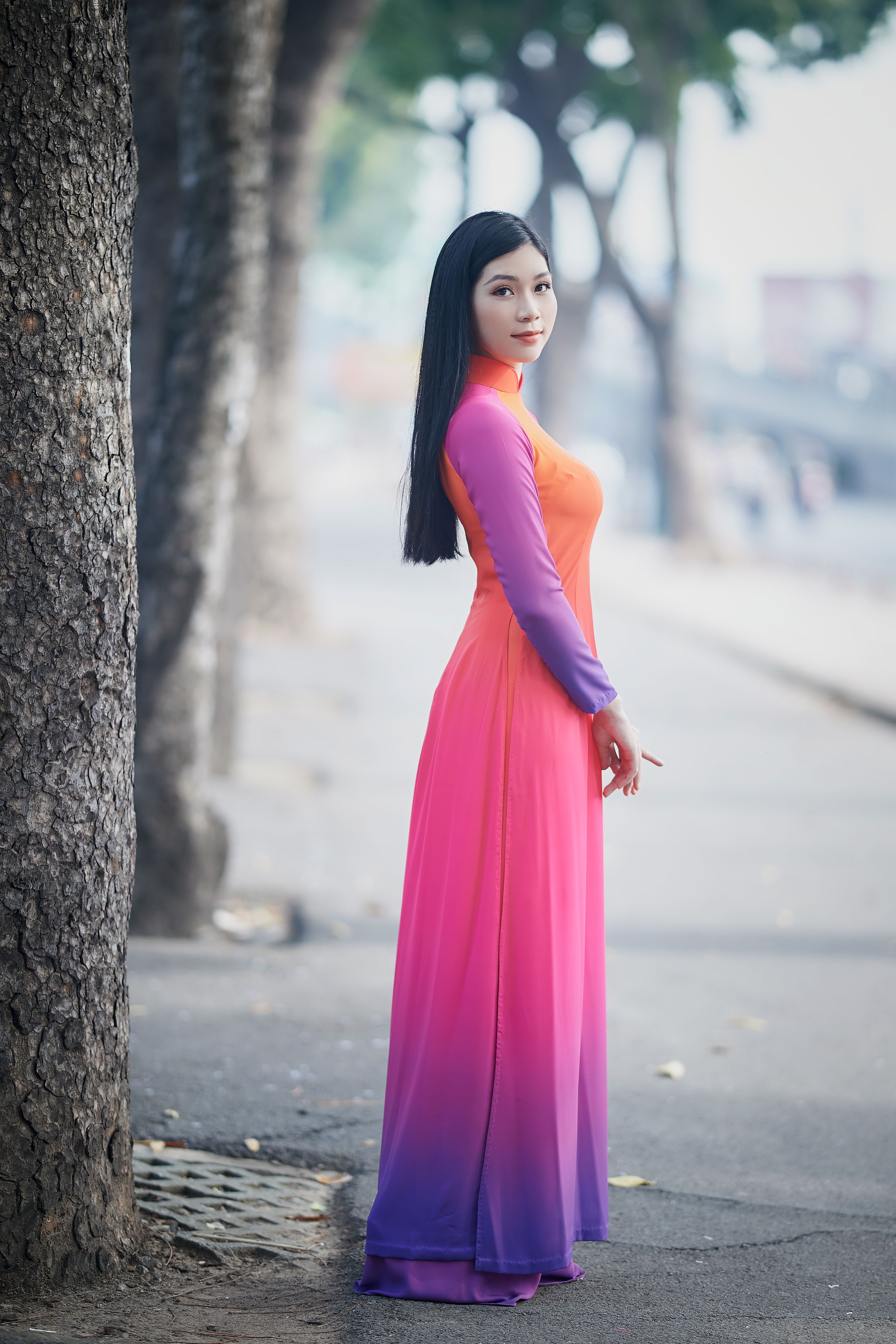 Woman in Long Sleeve Dress Standing Beside a Tree · Free Stock Photo