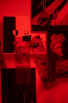  Sections of Camera Film Drying on String and Photo Pictures Pinned to Wall 