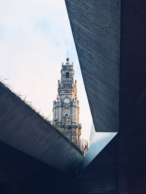 Free View of Clérigos Tower through modern architectural concrete structures in Porto, Portugal. Stock Photo