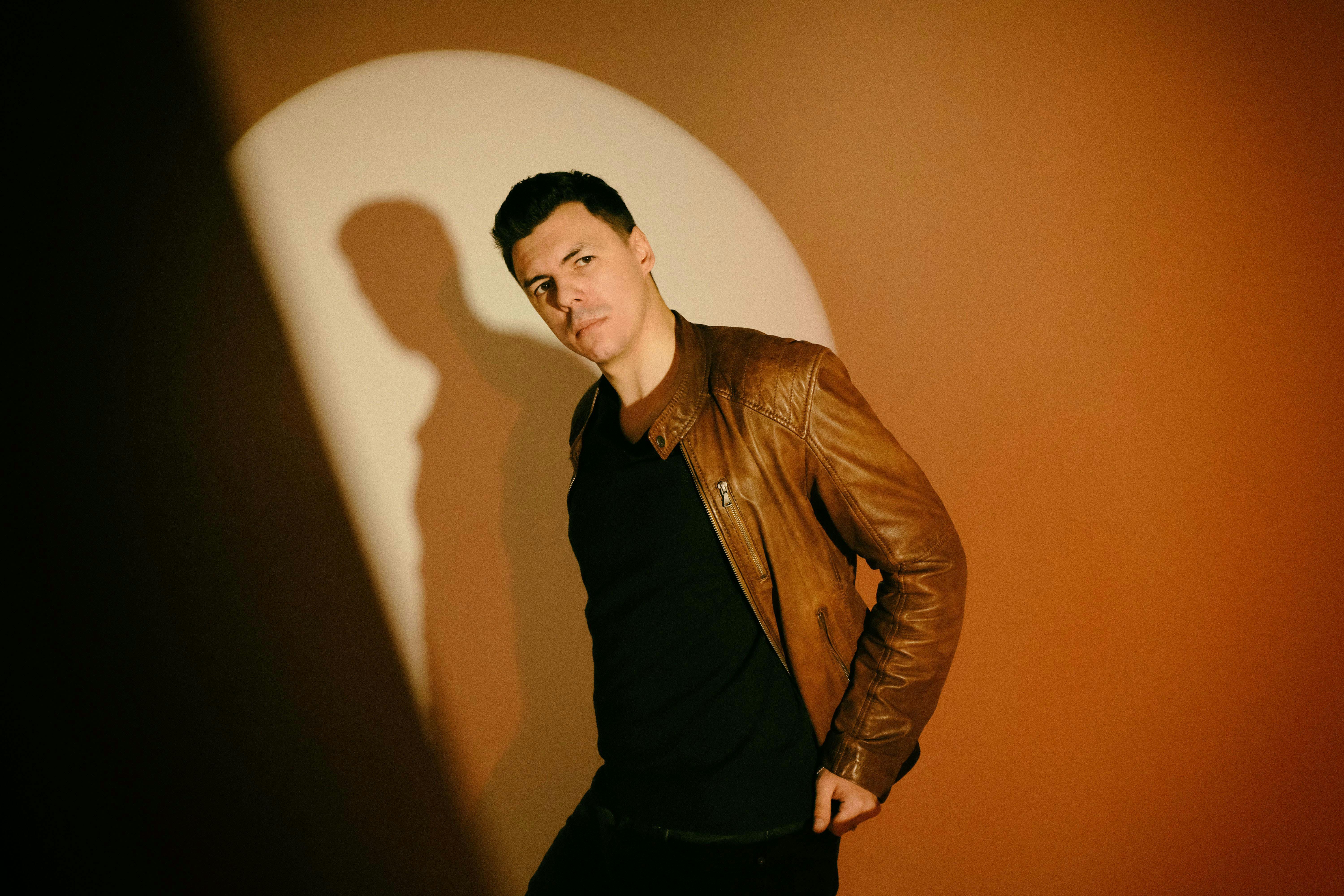 Cropped Shot Of Stylish Man In Leather Jacket Holding Golden