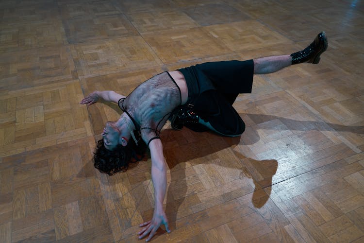 A Flexible Man Bending While On The Floor