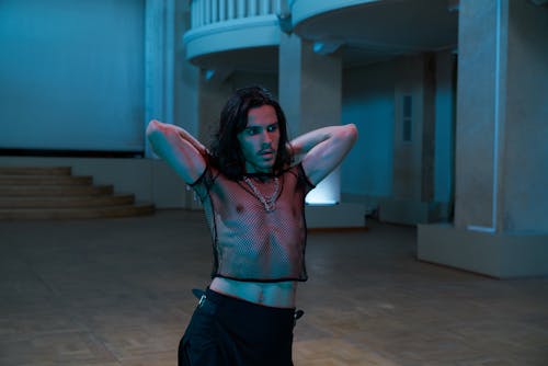 Man with Long Hair Dancing in a Hall