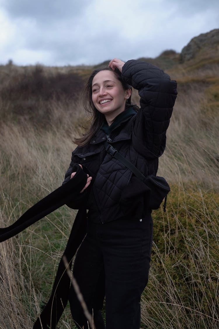 Woman In A Black Jacket Fixing Her Hair