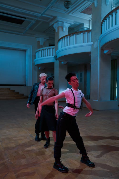 Three Dancers Posing in a Room