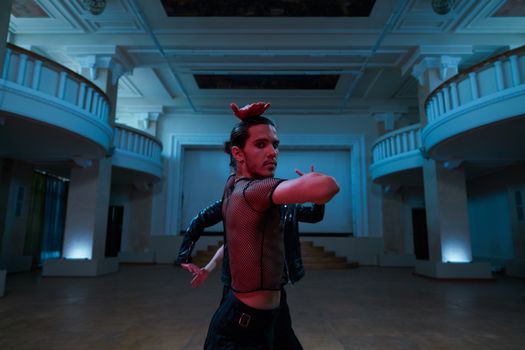 Dynamic portrait of a contemporary dancer striking a pose in a grand hall.