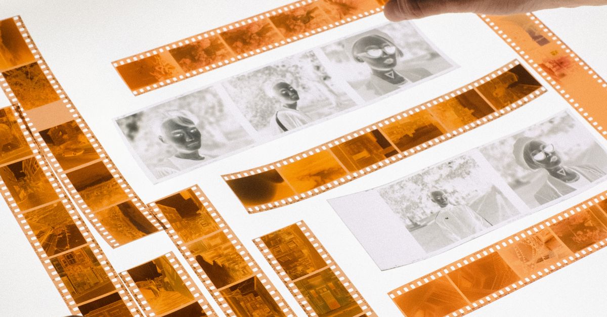 Man Developing Camera Film on Light Table · Free Stock Photo