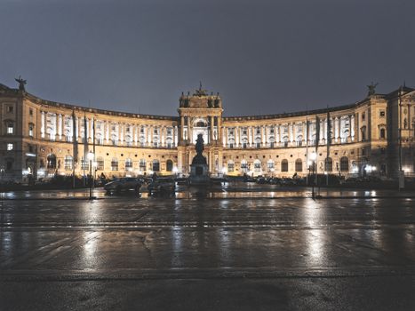 Illuminated view of Hofburg Palace in Vienna, Austria at night.