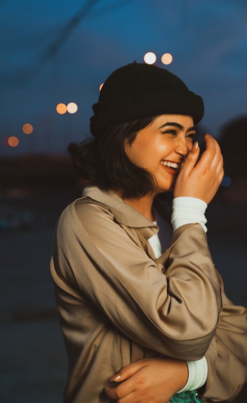 Woman Wearing a Beanie and Coat Smiling