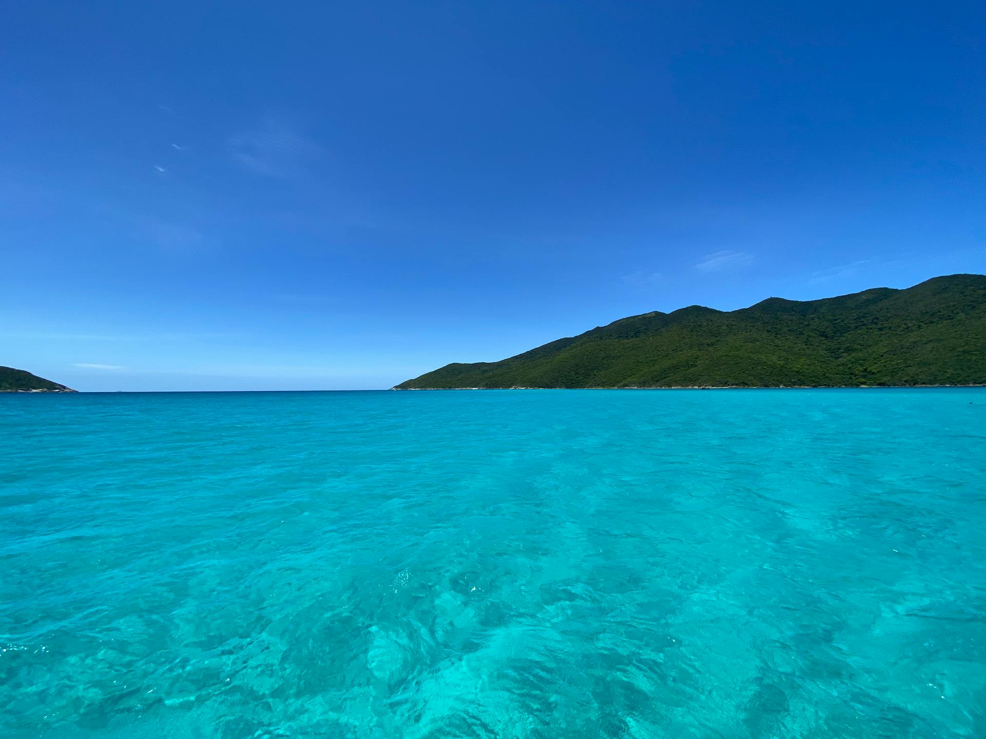 Breathtaking view of turquoise waters and lush islands under a clear blue sky.
