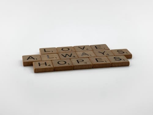 Free Wooden Scrabble Pieces on White Surface Stock Photo