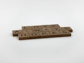 Wooden Scrabble Pieces on White Surface