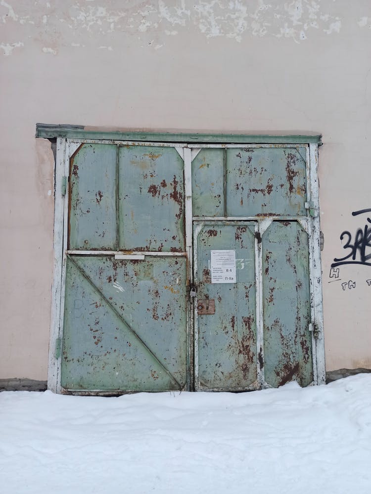 Old Metal Entrance Door To An Industrial Buildling