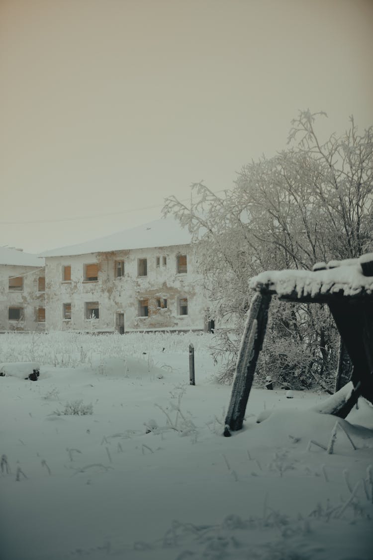 An Abandoned Building Covered In Snow