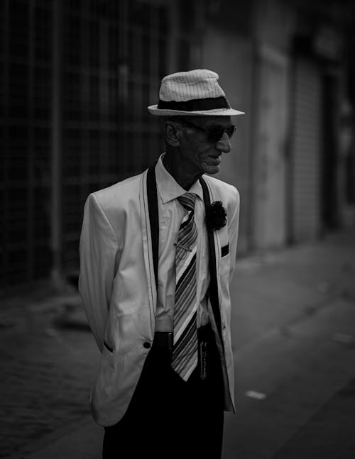 Free Monochrome Photograph of an Elderly Man with Sunglasses Wearing a Suit Stock Photo