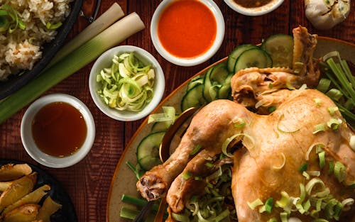 Top View of Chicken with Leek and Sauces on a Table