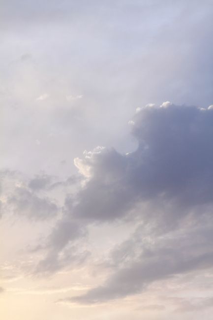 Soft pastel clouds over Sabaudia, Italy, captured at twilight, depicting a serene and tranquil atmosphere.
