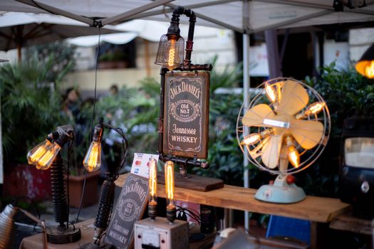 Retro display featuring Jack Daniels sign with vintage Edison bulbs and antique fan.