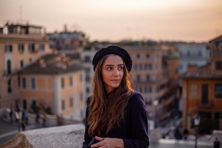 Woman In Beret On Roof Overlooking City