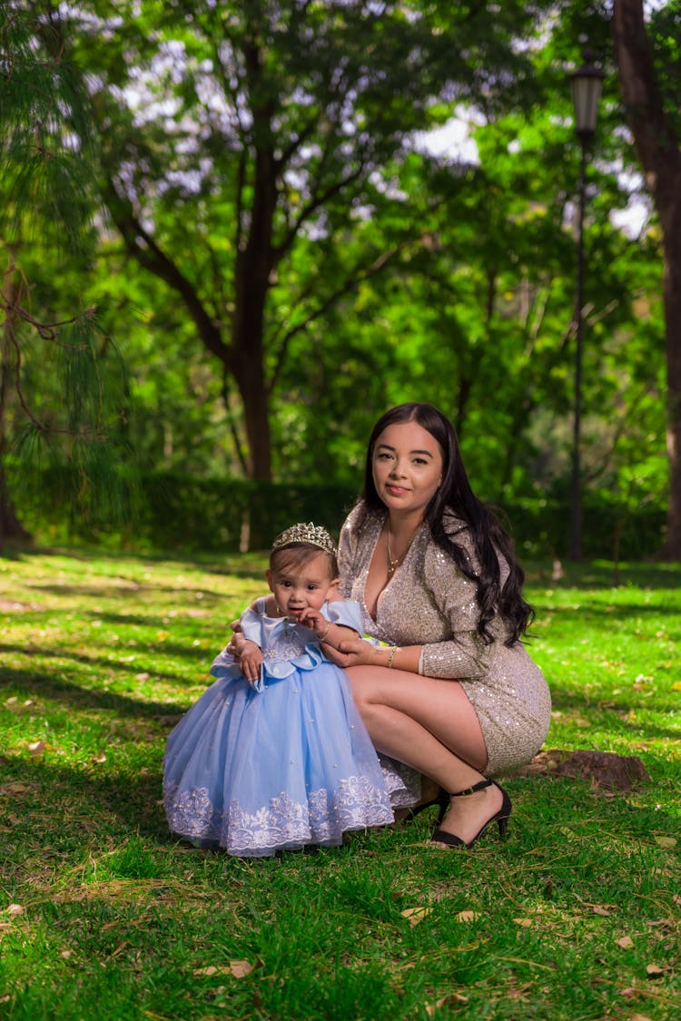 Woman With A Little Daughter In A Blue Dress And Tiara 