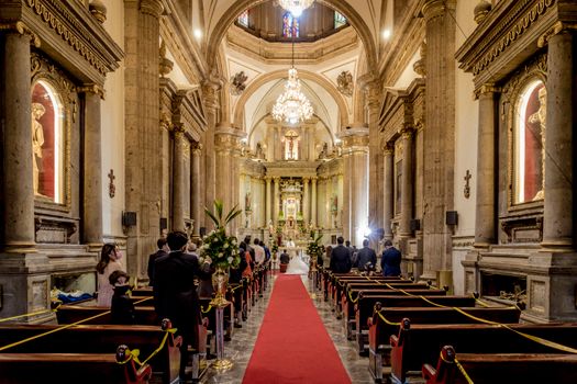 A beautiful wedding ceremony in a grand cathedral with ornate architecture.