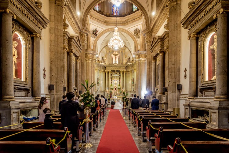 People Inside A Church Witnessing A Wedding