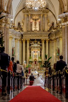 A beautiful church wedding ceremony with bride and groom at the altar.