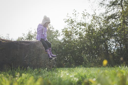 A Girl Sitting on a Rock