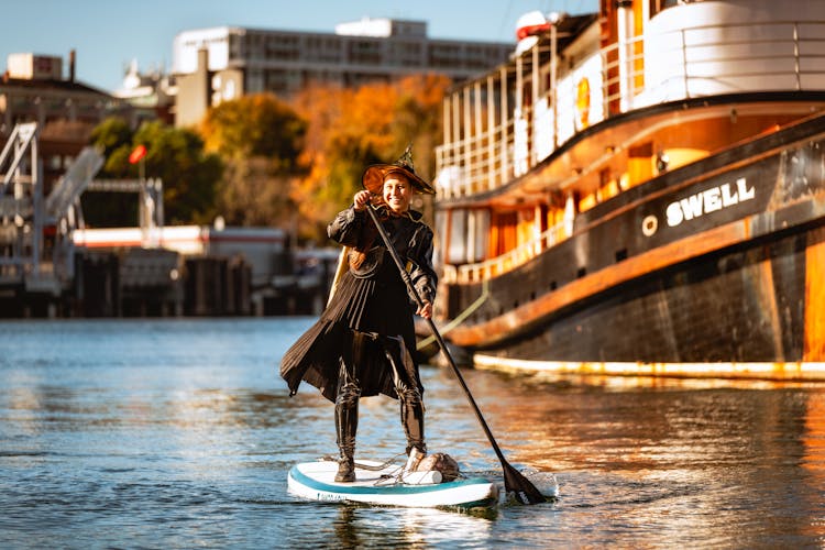 Woman In Black Dress Paddleboarding