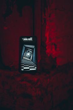 A surreal digital art piece showing an infinite checkered hallway through a cellphone screen.